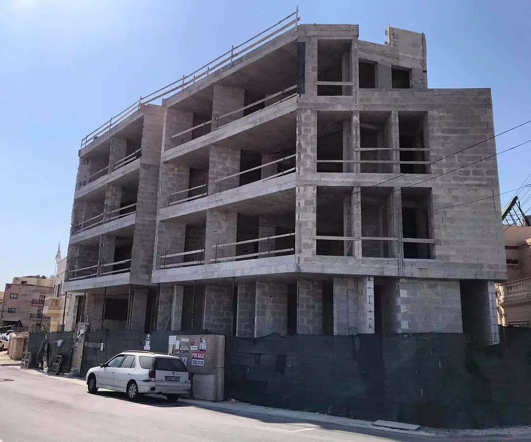 An apartment building under construction with bare floors