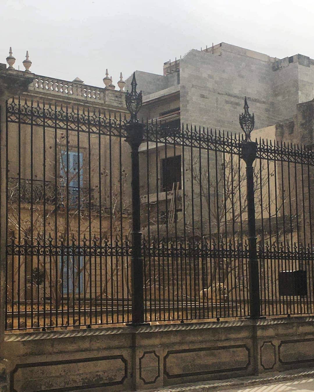 A building under construction behind security railings