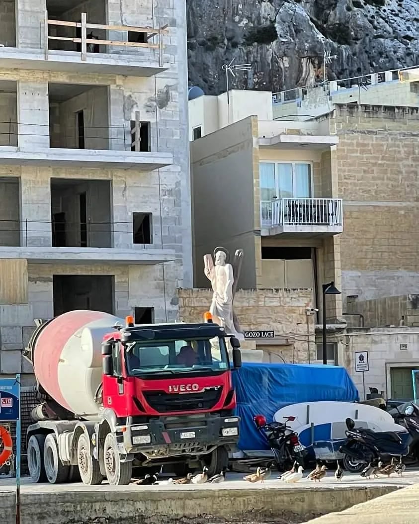 A cement mixer truck on a construction site