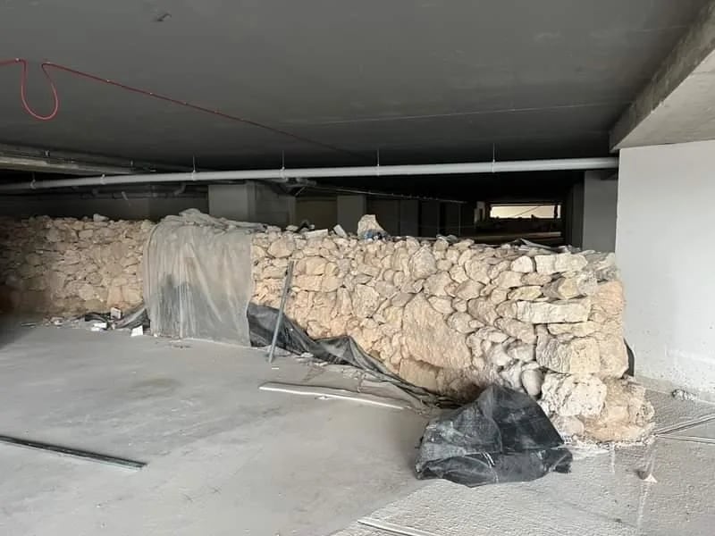 An open excavation beneath a building