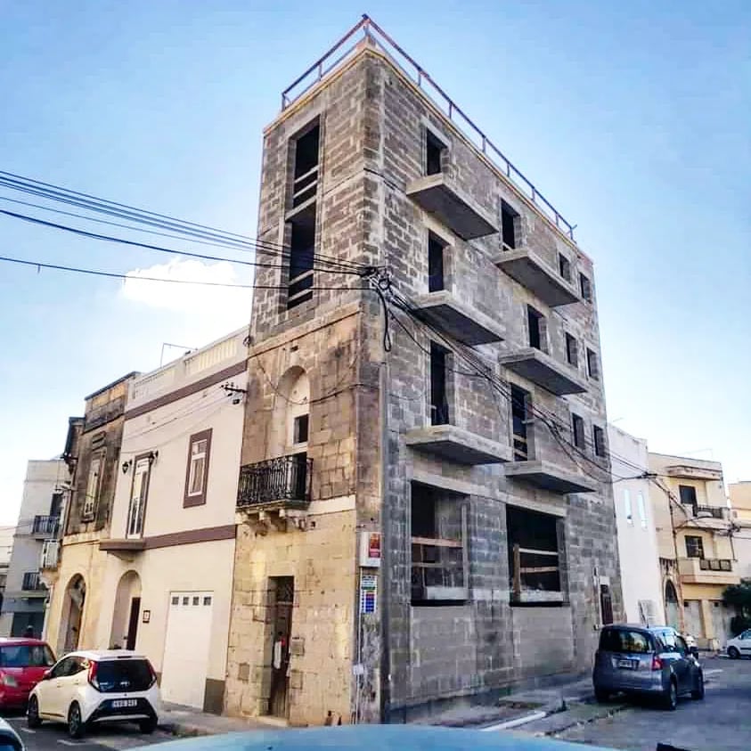 A weathered townhouse on a street corner
