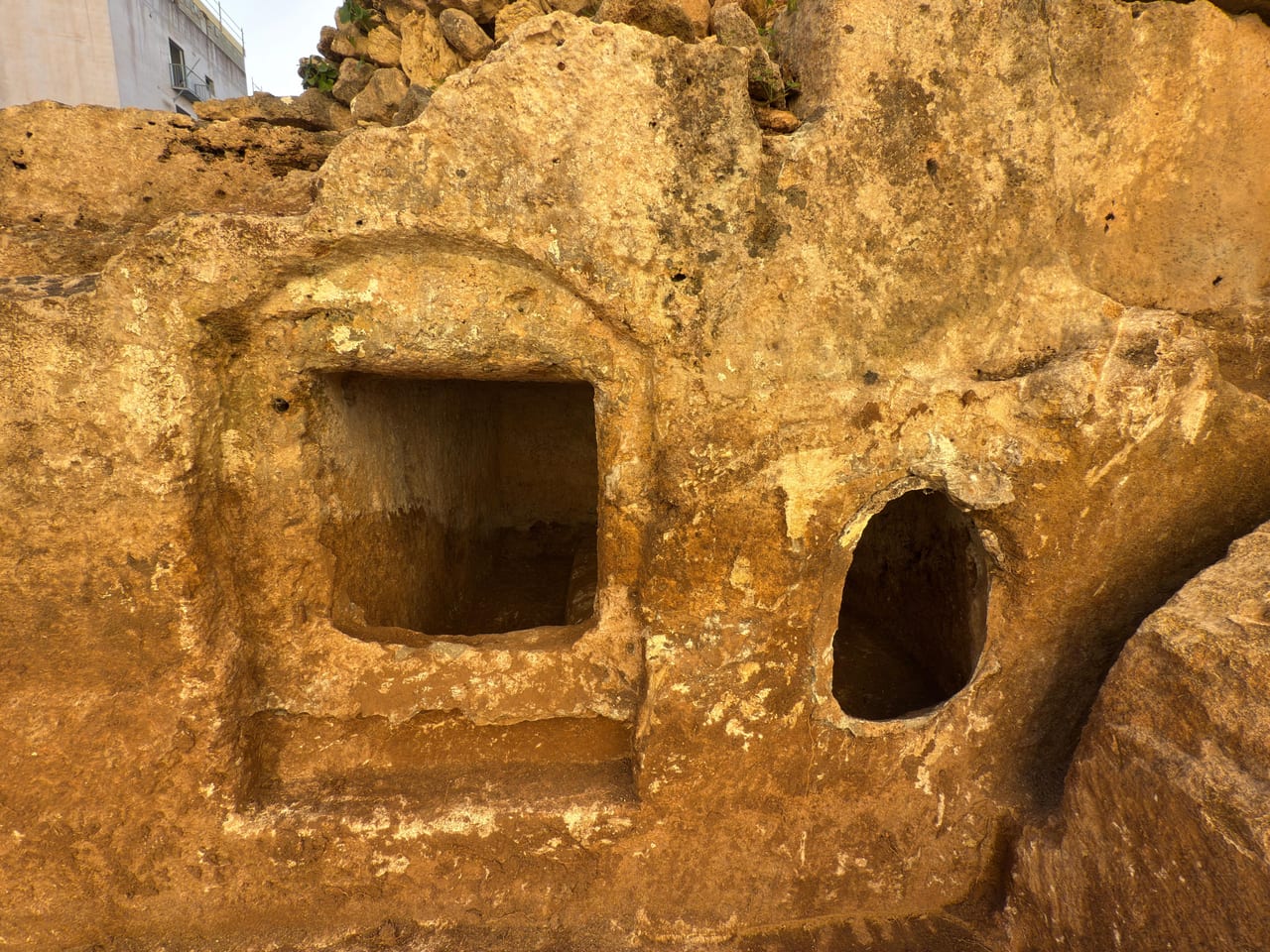 Roman rock-cut burial chambers in golden limestone at Triq il-Fugass, Qawra