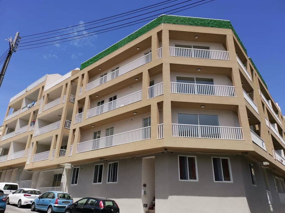 A modern apartment block with tinted-glass balconies