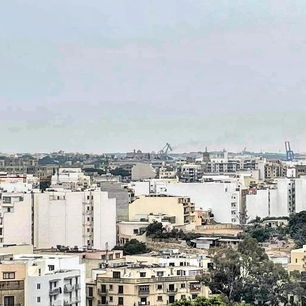 A dense spread of rooftops to the horizon
