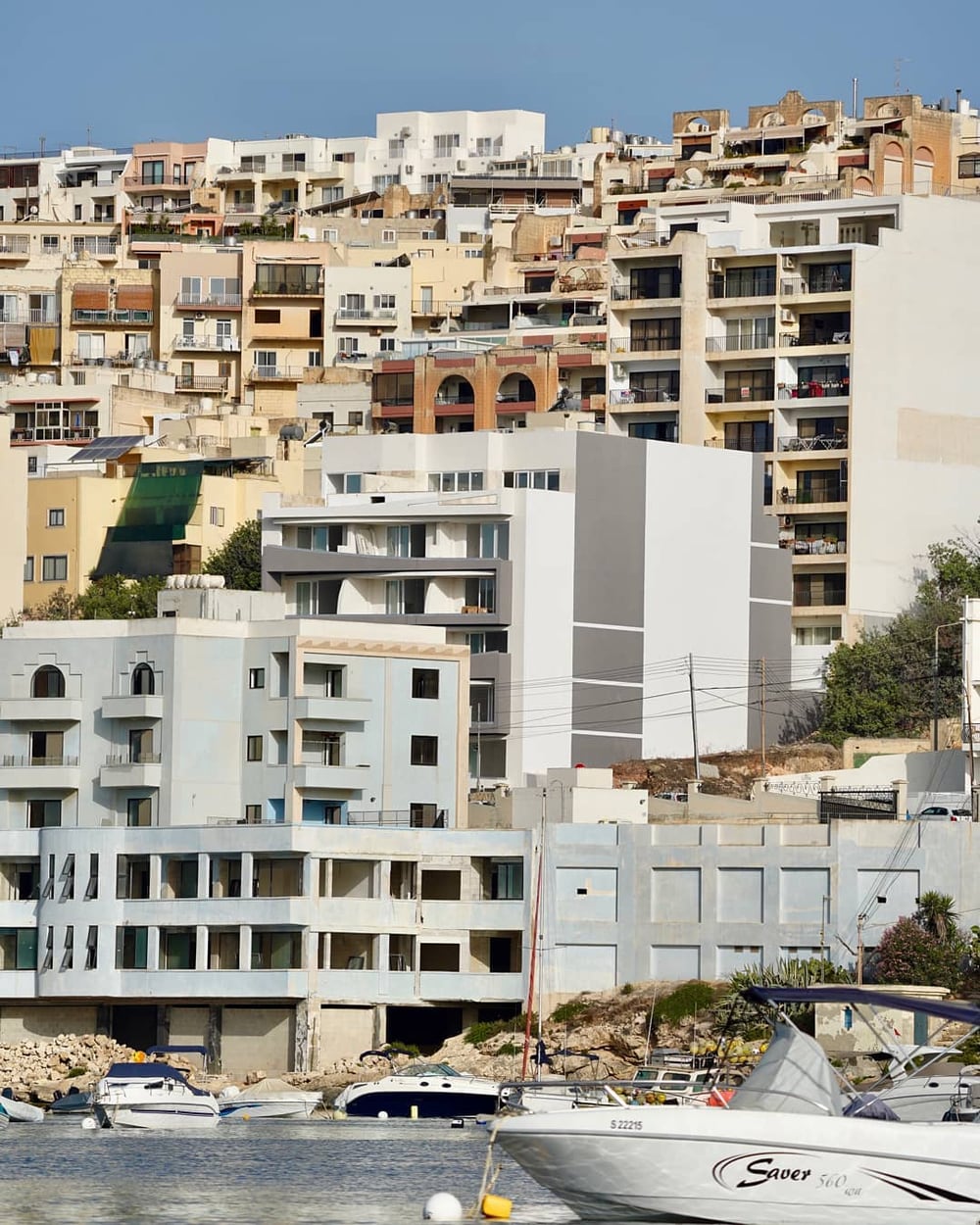 White apartment blocks stacked up a hillside
